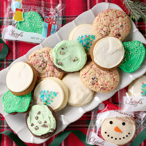 A platter of Cheryl’s holiday-themed cookies includes frosted cookies with various designs like snowflakes and a snowman, presented on a festive red and green plaid background.