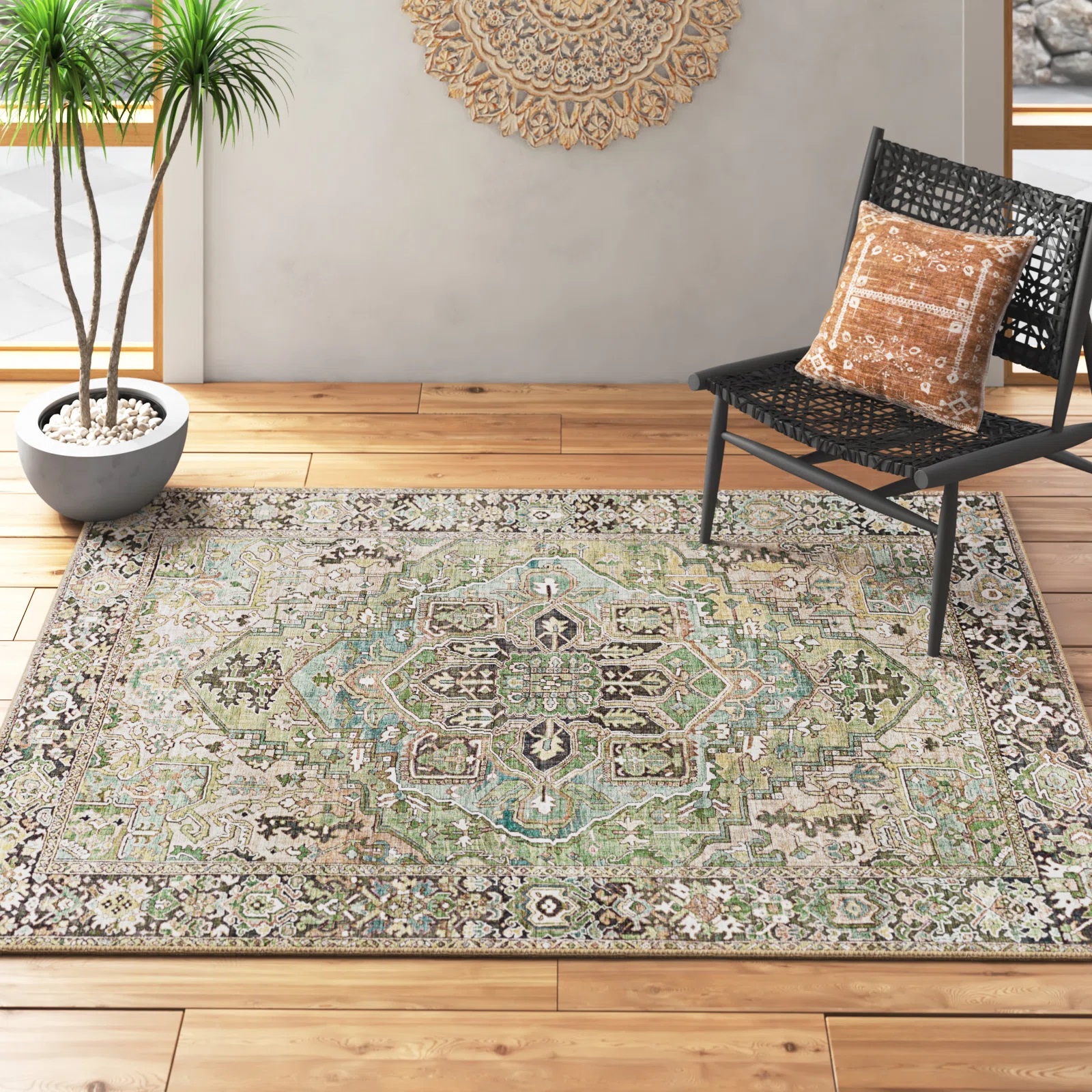A decorative area rug with intricate patterns, paired with a black chair featuring a patterned cushion on a wooden floor.