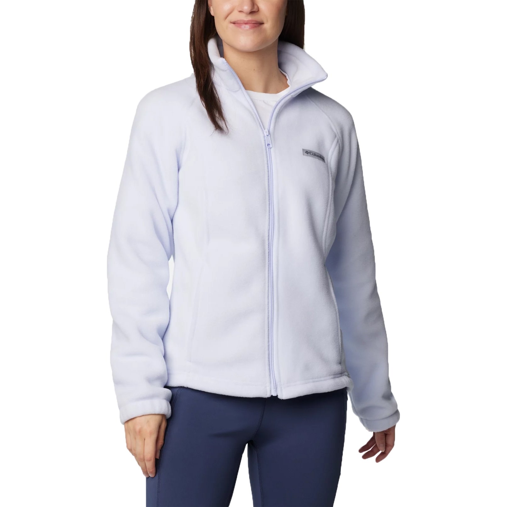 A light blue fleece jacket with a full zip, featuring a high collar and the Columbia logo on the chest, paired with navy blue pants.