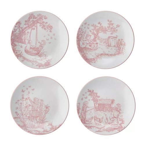 Set of four decorative plates featuring red toile-style designs with pastoral scenes, including children playing, a doghouse, and a person picking flowers.