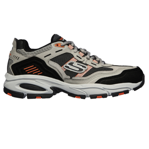 A gray and black athletic shoe with orange accents and a distinctive \“S\“ logo on the side, featuring a thick white sole with black and orange tread details.