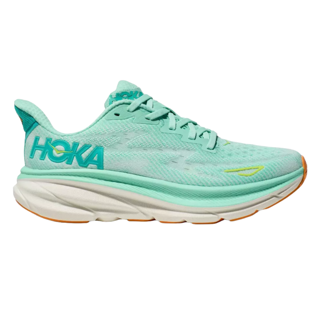 Hoka Women's Clifton 9 Shoes are light turquoise with a teal \“Hoka\“ logo, featuring a breathable mesh upper and cushioned midsole for comfort and support. The outsole is white with an orange accent, designed for running and everyday wear.