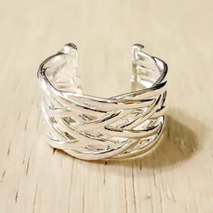 Silver-tone open ring with an intricate woven design, featuring overlapping strands and an adjustable fit.