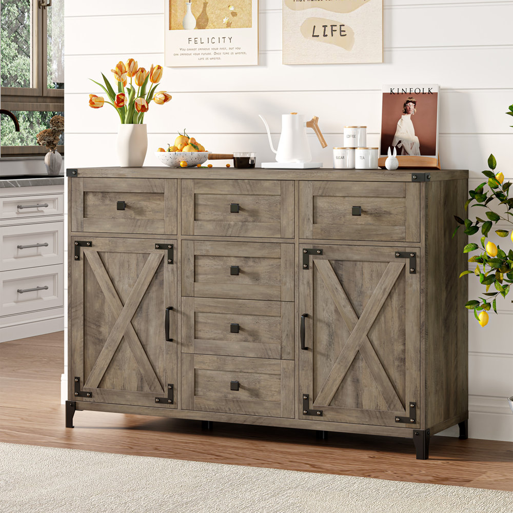 A wooden 6-drawer sideboard with two barn-style sliding doors, featuring metal handles and a rustic gray finish.