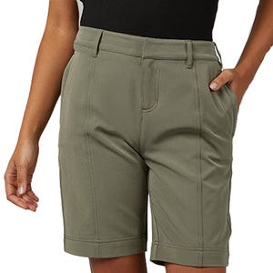 A person wearing knee-length olive green shorts with belt loops and side pockets.