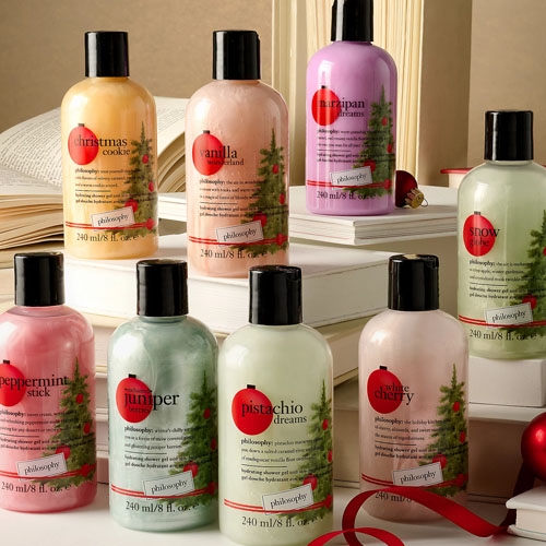 A collection of Philosophy brand shower gels with Christmas-themed scents like peppermint stick and Christmas cookie.