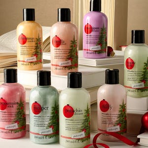 A collection of Philosophy brand shower gels with Christmas-themed scents like peppermint stick and Christmas cookie.