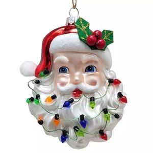 Santa ornament with a classic face, red hat adorned with holly, and beard wrapped in colorful Christmas lights.