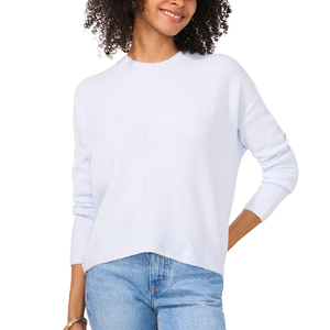A Vince Camuto crewneck sweater in a soft, light blue shade with a relaxed fit and ribbed cuffs, paired with light blue jeans.