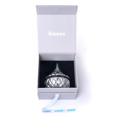 A Hershey's Kisses decorative container resembling the iconic candy shape is shown in an open presentation box with a Hershey's Kisses label.