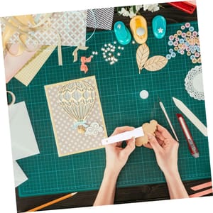 A One-Year Craftsy Membership provides access to a variety of crafting classes and projects, including scrapbooking and cardmaking, along with tools like paper punches, craft knives, and embellishments such as buttons and ribbons for creative projects.