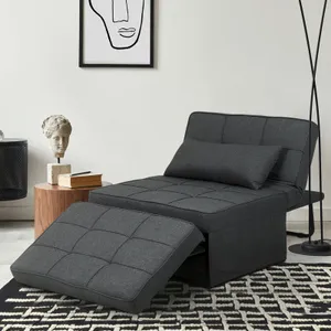 A gray lounge chair with an adjustable backrest and matching footrest is positioned on a patterned rug next to a side table and under a framed wall art piece.