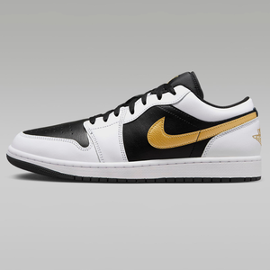 A pair of Air Jordan 1 Low sneakers featuring a black and white color scheme with a metallic gold Nike Swoosh and the Jumpman logo on the heel.