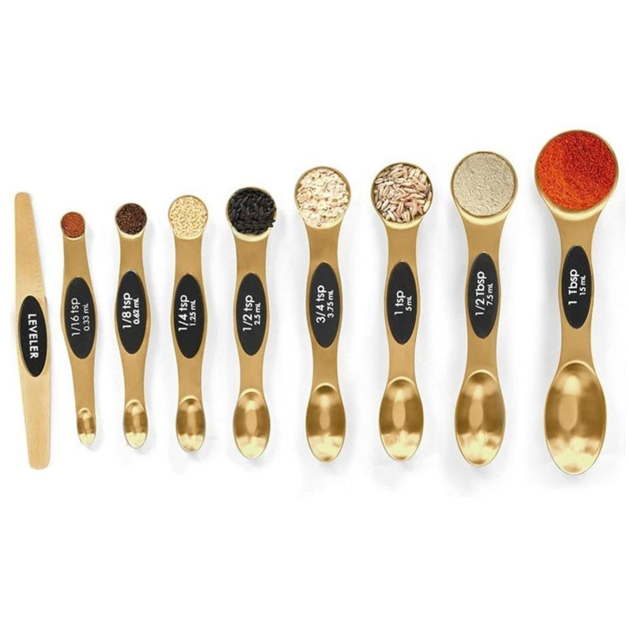 A set of gold measuring spoons and a leveler, including sizes from 1/16 tsp to 1 tbsp, each filled with different spices.