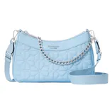 Light blue quilted shoulder bag with a chain and adjustable strap, featuring a floral pattern and the brand name \“Kate Spade New York\“ embossed on the front.