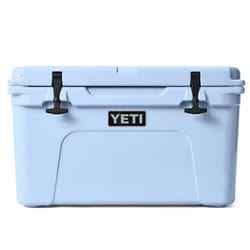 A light blue YETI cooler with black latches and the YETI logo on the front.