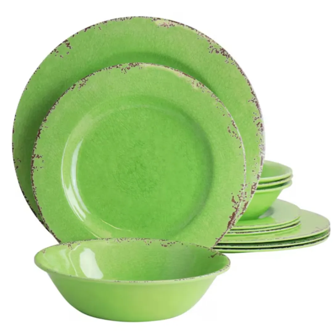 A set of green dishware with a distressed edge design, including plates and a bowl.