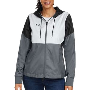 A color-block zip-up hooded jacket features a blend of gray, black, and white with a small logo on the chest, worn by a person in jeans.
