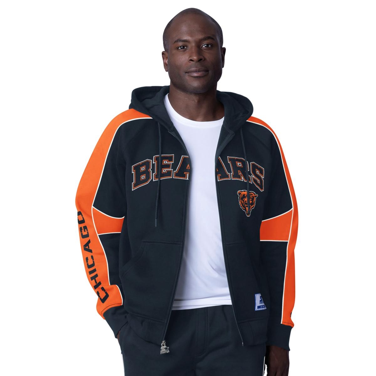 A man is wearing a black and orange Chicago Bears full-zip hoodie with bold team lettering and logo.