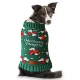 A dog wears a green Christmas sweater with \“Obviously Naughty\“ embroidered on it, featuring red bows and white snowflakes.