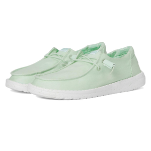 Mint green casual shoes with white soles, featuring a slip-on design and laces, suitable for a relaxed, comfortable style.