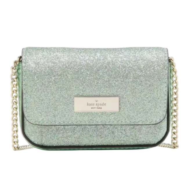 A green glitter crossbody bag with a gold chain strap and a \“Kate Spade New York\“ logo plaque on the front flap.