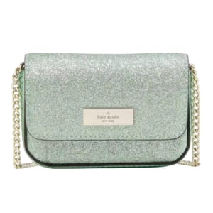 A green glitter crossbody bag with a gold chain strap and a \“Kate Spade New York\“ logo plaque on the front flap.