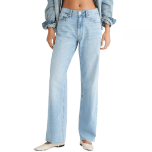 Light blue high-waisted, wide-leg jeans paired with a denim jacket and cream-colored shoes.