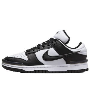 A black and white Nike sneaker with a low-top design, featuring the iconic swoosh logo on the side, perforated toe box, and a white midsole.