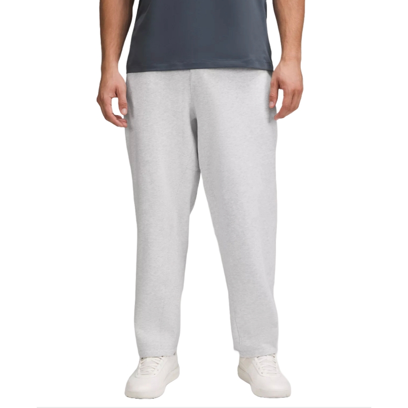 Gray sweatpants with a relaxed fit, paired with white sneakers and a dark gray shirt.