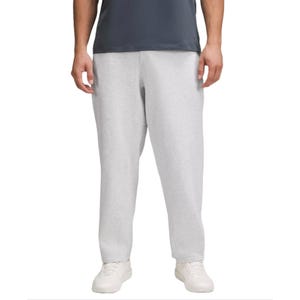 Gray sweatpants with a relaxed fit, paired with white sneakers and a dark gray shirt.