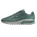 A green Nike Air Max shoe featuring mesh upper, visible air cushioning, and a textured midsole for added support.