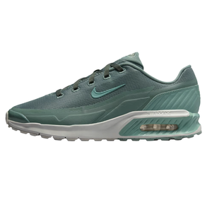 A green Nike Air Max shoe featuring mesh upper, visible air cushioning, and a textured midsole for added support.