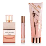 A Catherine Malandrino Dream gift set featuring a bottle of perfume, a travel-size rollerball, and a tube of scented cream, all in pink and gold tones.