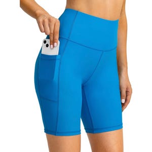 Bright blue high-waisted workout shorts with side pockets, designed for fitness activities, featuring a snug fit and suitable for carrying small items like a phone.