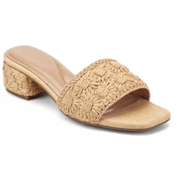 A beige, woven heeled sandal with an open toe, featuring a low block heel and intricate floral pattern on the strap.