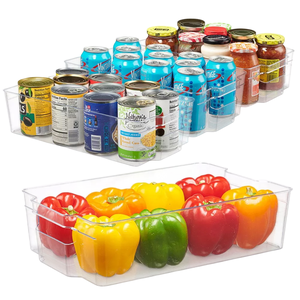 Clear storage organizers hold cans, jars, and bell peppers.