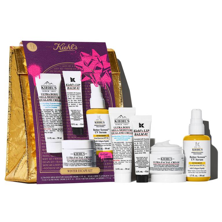 Kiehl's \“Winter Escape Kit\“ includes: Ultra Body Mega Moisture Squalane Cream, Ultra Facial Cream, Better Screen UV Serum, and Lip Balm #1, packaged in a gold and purple set.