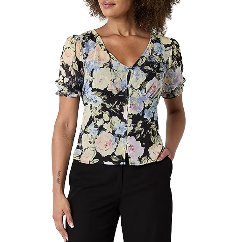 The Brennan Floral Top features a V-neck and button-up design with short, ruched sleeves. It showcases a pastel floral pattern on a black background, creating a delicate and stylish look.