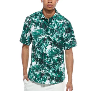 A short-sleeved button-up shirt with a green and white tropical leaf pattern, paired with white pants.