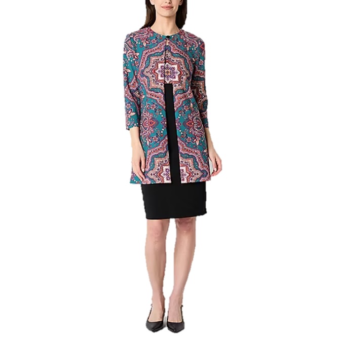 Long-sleeve coat with a vibrant, geometric pattern over a black dress; paired with black high heels.