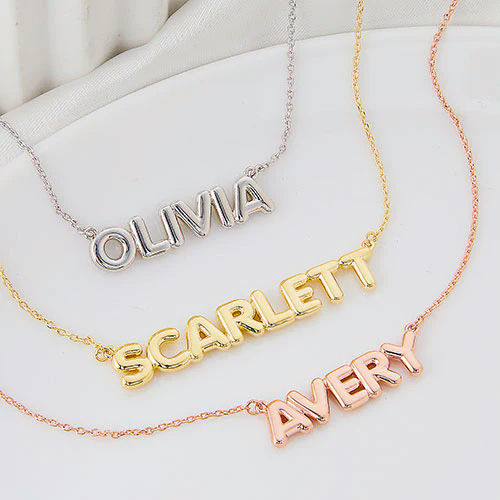 Three personalized name necklaces in silver, gold, and rose gold finishes.