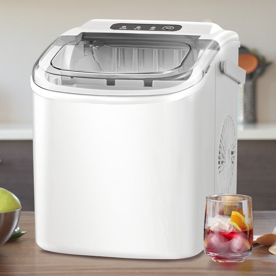 Countertop ice maker with a clear lid displaying ice trays inside, situated next to a glass of ice-filled drink on a kitchen countertop.