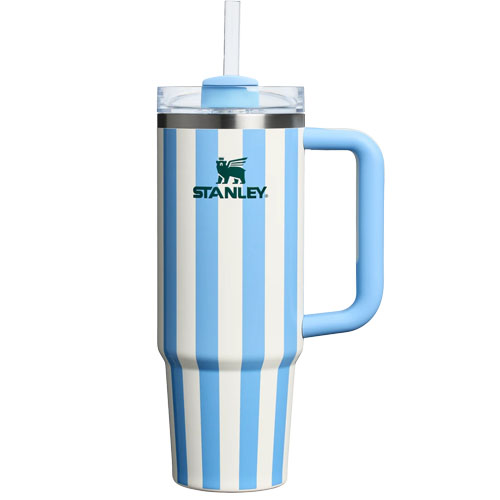 A Stanley striped tumbler with a handle and a straw, featuring light blue and white vertical stripes.