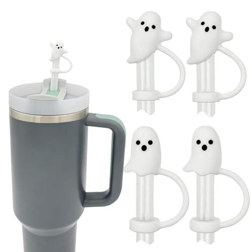 Four white ghost-shaped straw toppers designed for Halloween, with one displayed atop a straw in a grey tumbler.