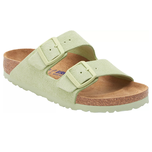Light green sandal with two adjustable buckles and a cork footbed, featuring a textured sole for grip.
