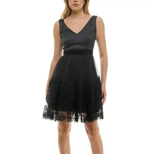 A sleeveless black dress with a V-neckline and fitted waist, featuring an embellished mesh skirt with lace detailing at the hem, creating a layered effect.