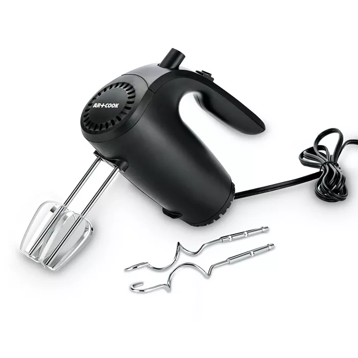 A black hand mixer with a pair of beaters attached and two dough hooks lying next to it.