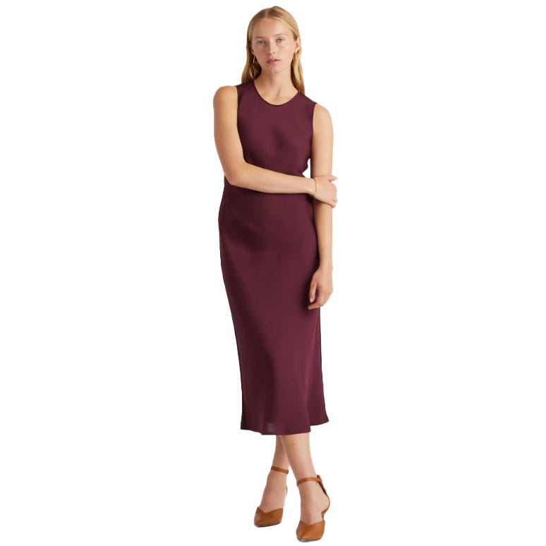 Sleeveless burgundy midi dress made from washable silk, featuring a round neckline and a sleek, fitted silhouette, paired with brown ankle-strap heels.
