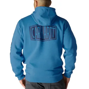 Blue Carhartt hoodie with a large logo on the back, worn by a person facing away, paired with dark pants.